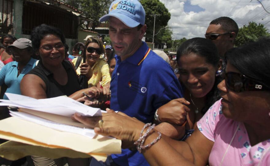 Gov. Henrique Capriles, third from right, receives written petitions from residents during a rally in Ocumare Del Tuy, Venezuela. Capriles, who is the governor of Miranda state in Venezuela, was statistically tied with President Hugo Chavez in a recent poll for next year's presidential election.