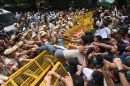 Supporters of the Cockroach Janta Party scuffle with police as they attempt to march to India's Parliament, demanding the resignation of the education minister, in New Delhi, Monday.