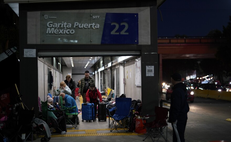 Ukrainian refugees wait in a bus stop near the Mexico border in early April. The arrival of hundreds of Ukrainians at the border since the war began has added more pressure on the Biden administration to lift Title 42.
