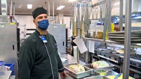 Scripps Memorial Hospital Chef Tim Watson stands in front of turkeys ready to be roasted.