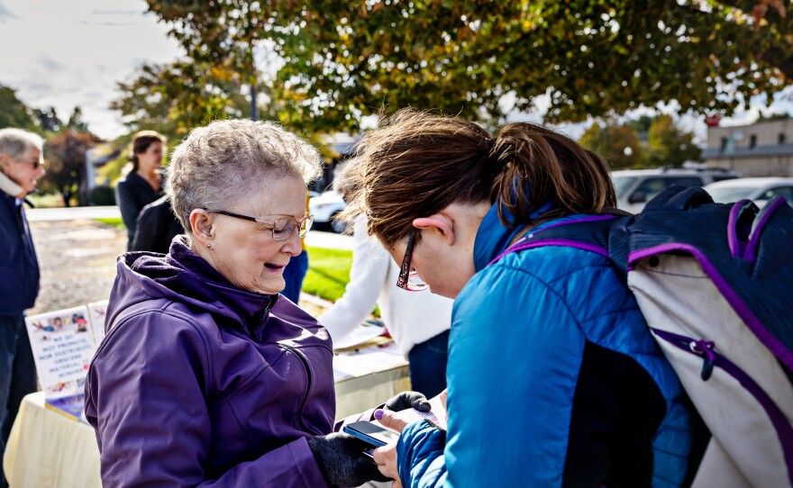 Halli Stone (left) of Parents Against Bad Books persuades Samantha Neis to sign a petition protesting what the group considers obscene books at the Idaho Falls Public Library.