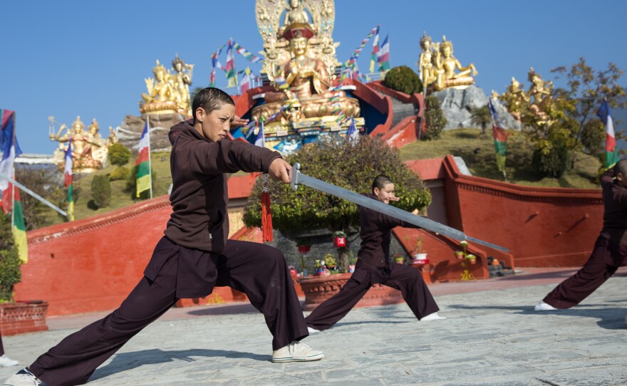 The nuns wield spears and dance in formation during their practice sessions.