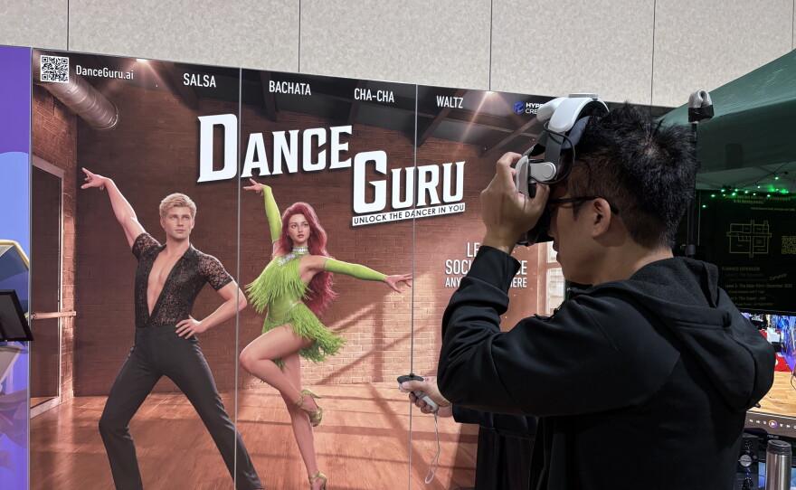 Entrepreneur David Huang tests out a VR headset while conducting demonstrations of the social dance lesson app Dance Guru at the Augmented World Expo in Long Beach, Calif., June 17, 2026.
