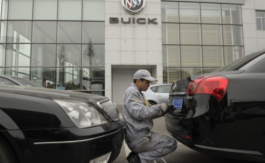 A mechanic works on a Buick at a General Motors dealership in Shanghai last December. GM just announced it plans to open 600 additional dealerships in China. The company now sells more cars in China than it does in the United States.