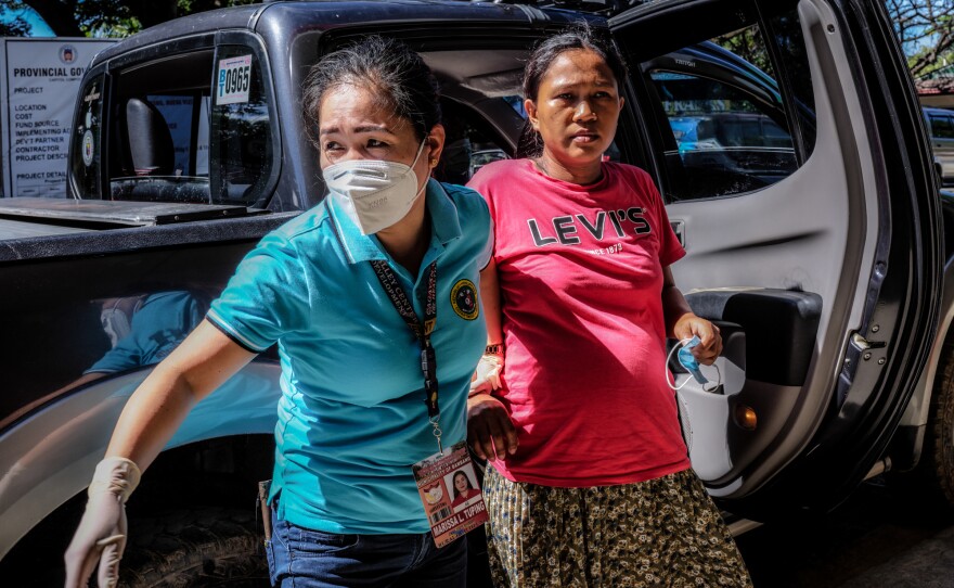Marissa Tuping, a rural midwife, and Risa Calibuso, right, arrive in Nueva Vizcaya Provincial Hospital on July 21. Calibuso gave birth to her son moments later.