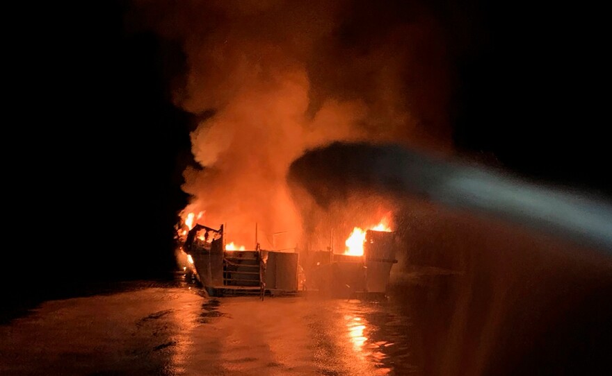 In this photo provided by the Ventura County Fire Department, VCFD firefighters respond to a boat fire off the coast of southern California, Monday, Sept. 2, 2019.