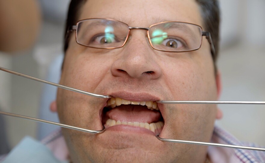 Host Jorge Meraz gets his teeth worked on at a dentist in Tijuana, Baja Calif.