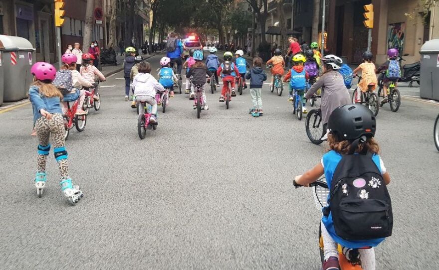 A police vehicle travels at the front of the bicibus in the Eixample district in Barcelona. When the group starts their commute on Friday mornings, they have help from local officials to keep everyone safe.