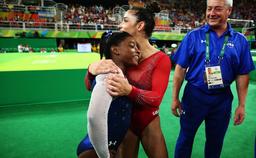 Raisman hugs Biles as they wait for Biles' score during Thursday's competition.