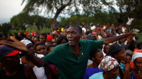 A Haitian man tries to get one of the last handouts of food rations at distribution site set up by the U.S. Army at a golf club on the hills above the Haitian capital, Port-au-Prince, Jan. 19, 2010. It is one of seven tent cities NPR visited to gauge the success of international relief efforts.