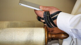 Rabbi Haim Ovadia reads the Torah to people attending a Zoom meeting of a virtual minyan from his Maryland home in 2020.