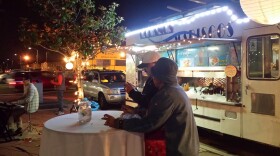 Residents attend Taste of Four Corners, a food market put on by the grass-roots group Urban Collaborative Project, at the intersection of Imperial and Euclid avenues in San Diego on Friday, Dec. 5, 2014.