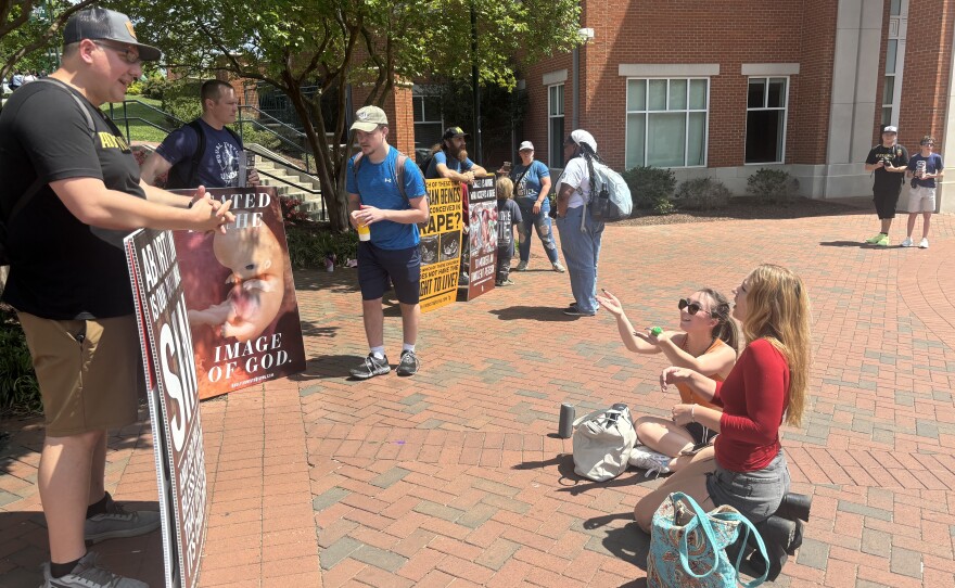 Jason Garwood, left, a Virginia pastor and anti-abortion activist who attended a conference hosted by the group Abolitionists Rising in April, argues with students at the University of North Carolina at Charlotte during an anti-abortion demonstration the group organized on the college campus.