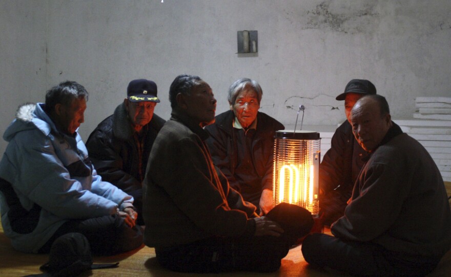 South Korean citizens gather in an underground shelter on Baengnyeong Island Monday, as their country's military began live-fire artillery drills from front-line islands near its disputed sea border with North Korea.