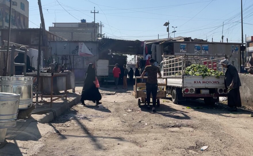 The entry to Al Wihelaat market in the working class Sadr City neighborhood of Baghdad, Iraq. Most vendors inside the market have stopped wearing masks, with many saying the pandemic is behind them.