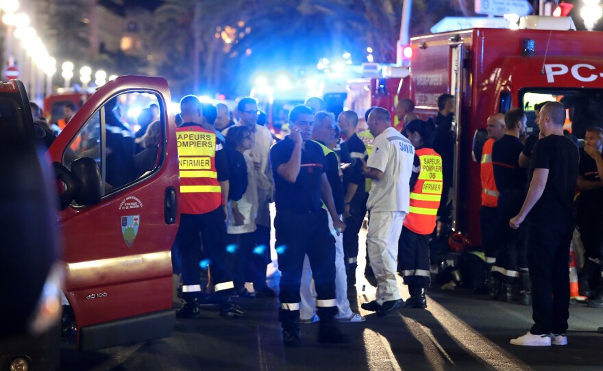 Police officers, firefighters and rescue workers at the Promenade des Anglais in Nice after a truck drove into a crowd watching a fireworks display in the French Riviera resort.