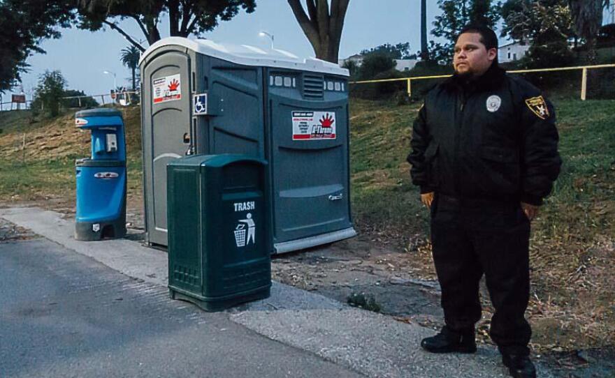 Bill Garcia with Premiere Security Group stands watch at the lot designated for safe parking at the West Los Angeles VA campus in this undated photo.