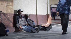 Carl Russell sits next to his homeless friend, Oscar Walker, in downtown San Diego in this undated photo. He sleeps upright and often fears being attacked while asleep. 