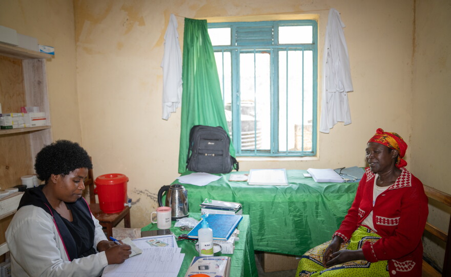 Nurse Diane Kwizera meets with Consolée Uwamaliya at a health facility near the Cyangoga Suspension Bridge, which spans a river that separates two communities. The bridge makes it easier for residents of the settlement on the other side of the river to come in for healthcare.