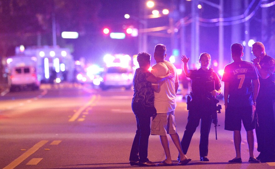 Orlando Police officers direct family members away from a fatal shooting at Pulse Orlando nightclub in Orlando, Fla., in June.