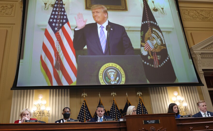 Then-President Donald Trump is seen on the screen above the House select committee investigating the Jan. 6 insurrection on Thursday in outtakes from his Jan. 7, 2021, video in which he refused to say he had lost the election.