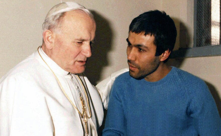 In a Dec. 1983 file photo provided by Vatican newspaper L'Osservatore Romano, Pope John Paul II meets Mehmet Ali Agca, in Agca's prison cell in Rome.