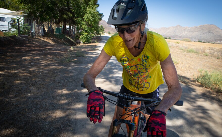 Raijah Thomas takes a break during a bike ride in Jacumba Hot Springs, Sept. 16, 2021. She frequently bikes on the paths between a field that has been approved as the location for a solar project and the Wagon Wheel Trailer Park, where she lives. 