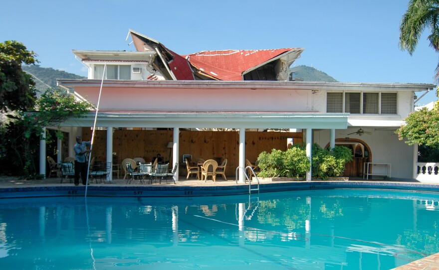 The hotel continued to operate after the devastating 2010 earthquake. The collapsed roof is visible behind the pool.