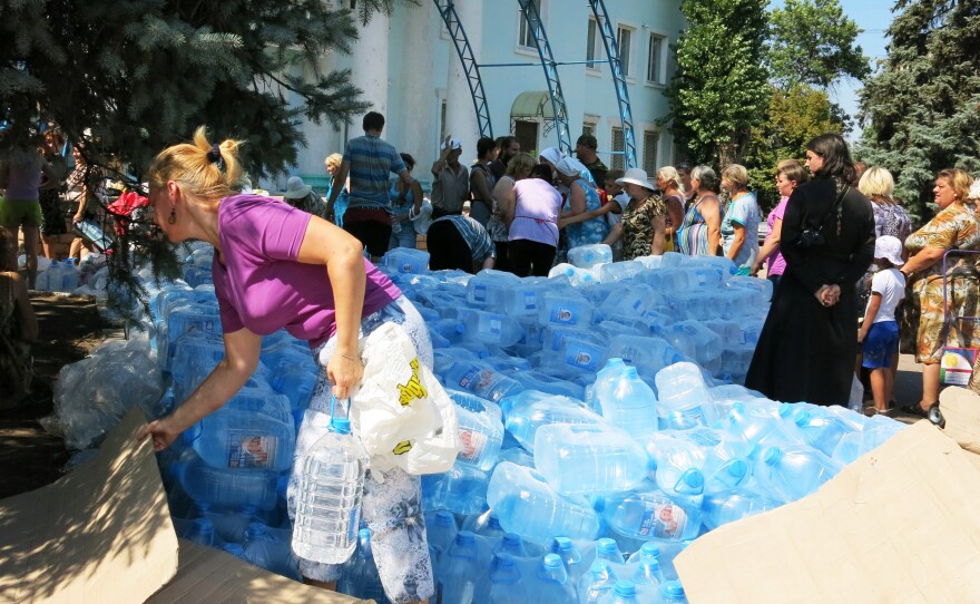 Ukrainian aid is doled out to people in Lysychansk.
