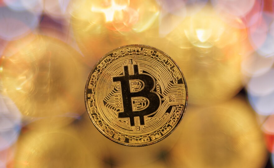 Bitcoin hit a record high following a rally sparked by the Securities and Exchange Commission's approval of bitcoin exchange-traded funds.