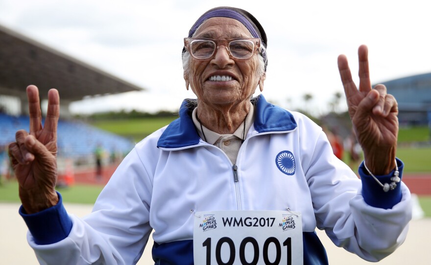 Centenarian Man Kaur of India celebrates after competing in the 100-meter sprint in the 100+ age category at an international event in Auckland on April 24, 2017.