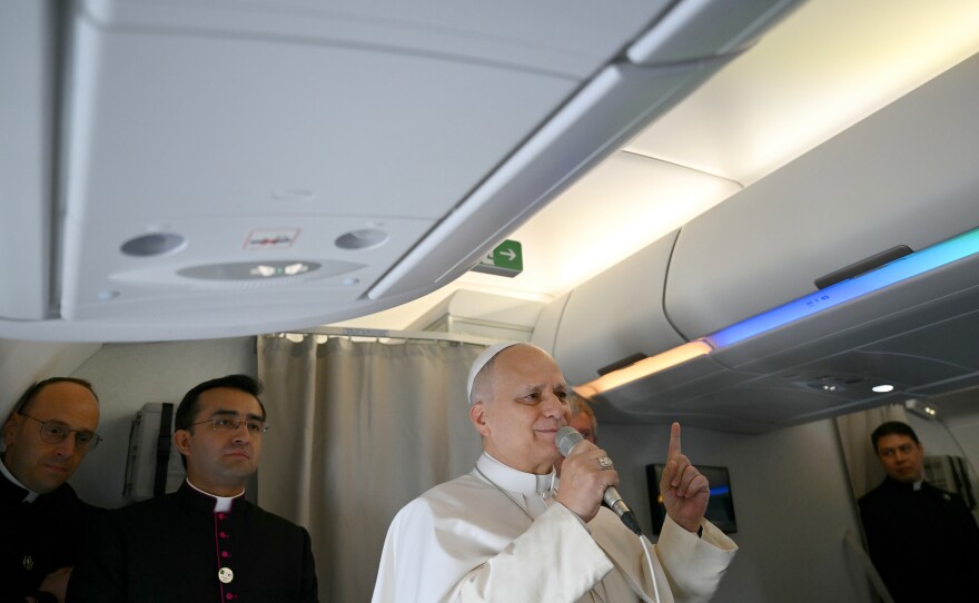 Pope Leo XIV speaks to journalists aboard his flight bound for Algiers' Houari Boumédiène International Airport on Monday, April 13, 2026, at the start of an 11-day apostolic journey to Africa.