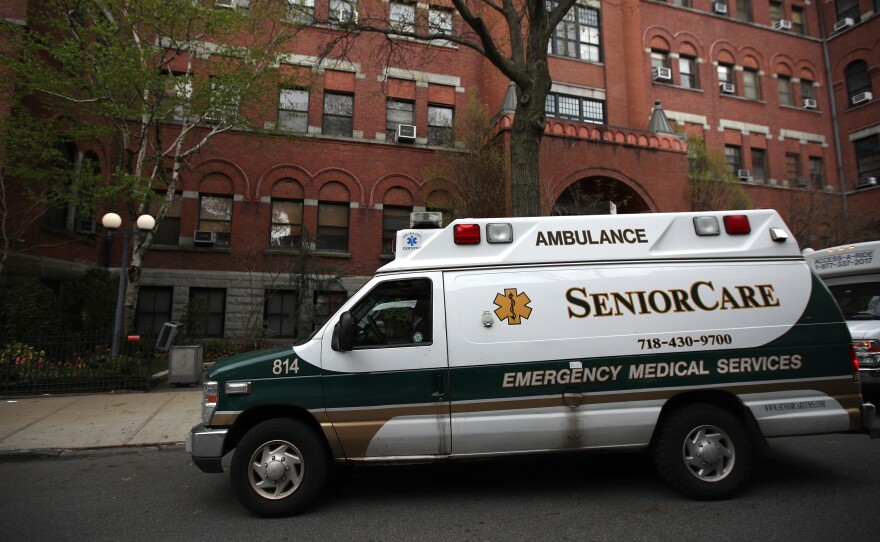 An ambulance pulls up outside a nursing home in Brooklyn, N.Y. Two senators have called for an investigation of five states, including New York, which ordered nursing homes to admit patients who tested positive for COVID-19.