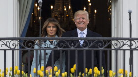 President Donald Trump and first lady Melania Trump arrives on the Truman Balcony of the White House in Washington, Monday, April 2, 2018, for the annual White House Easter Egg Roll. 