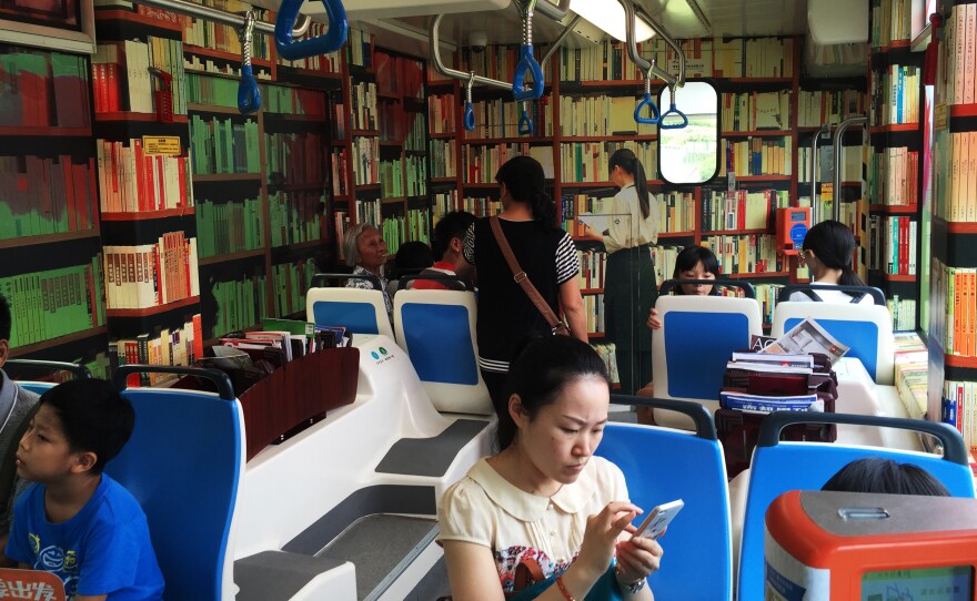Bookshelves are painted on the walls of a book-themed street car in Guangzhou.