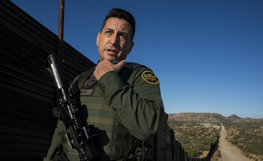 Border Patrol agent Joshua Wilson radios dispatchers to notify them of his location while touring the U.S.-Mexico border near Jacumba in eastern San Diego County on Sept. 5, 2017.