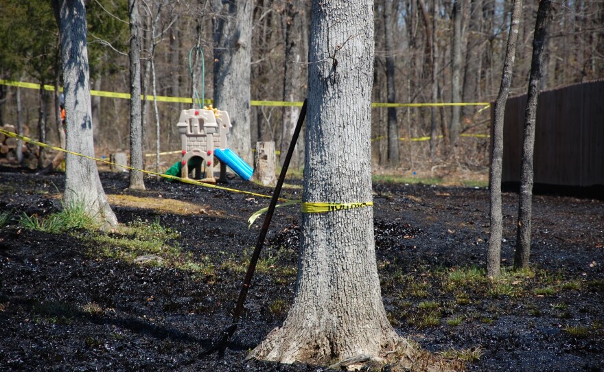 Oil covers the ground around a slide in Mayflower, Ark., on April 1, days after a pipeline ruptured and spewed oil over lawns and roadways.