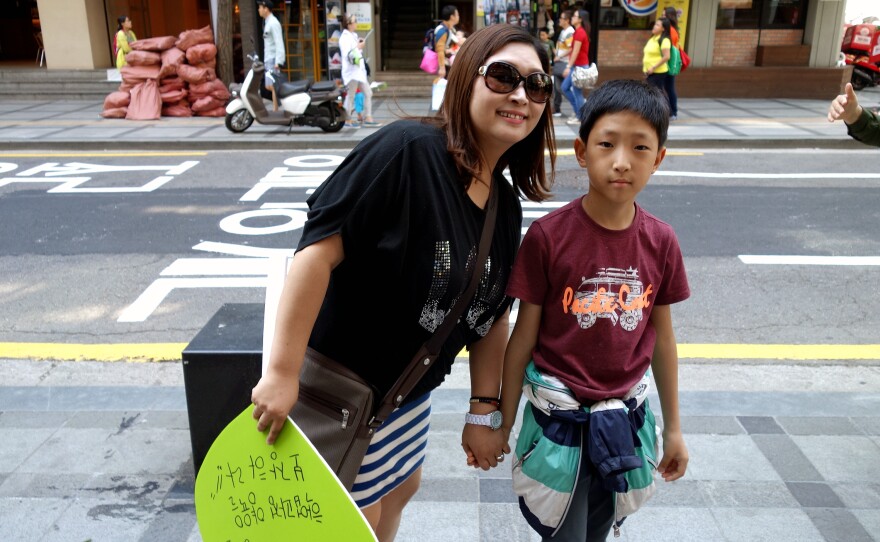 Choi Hyong-sook and her 11-year-old son during a march on Single Mom's Day. Her decision to raise him alone cost her ties with her family, and a string of jobs.