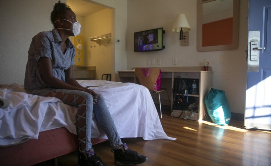 Jamie Burson sits on the bed of her motel room in Fairfield on August 4, 2020. Burson, who has been living between her car and motels since being evicted in April, said she feels unsafe at the motel and planned to move again later that day.