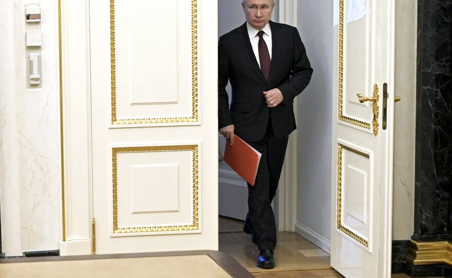Russian President Vladimir Putin enters a hall to chair a Security Council meeting in Moscow on Feb. 25.