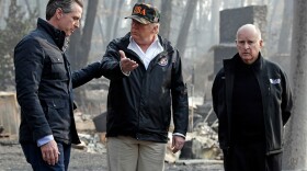 In this Nov. 17, 2018 file photo, President Donald Trump talks with Gov.-elect Gavin Newsom, left, as California Gov. Jerry Brown listens during a visit to a neighborhood impacted by the Camp wildfire in Paradise, Calif.