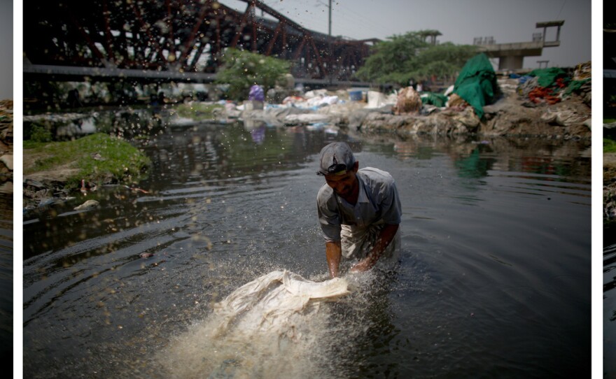 Mohammad Zamir, 38, washes pieces of cloth on the banks of the Yamuna River. He stands in the toxic water from 6:30 in the morning until 7 at night. Deflecting any talk of health issues, Zamir says his elders did the same work and lived a "long life."