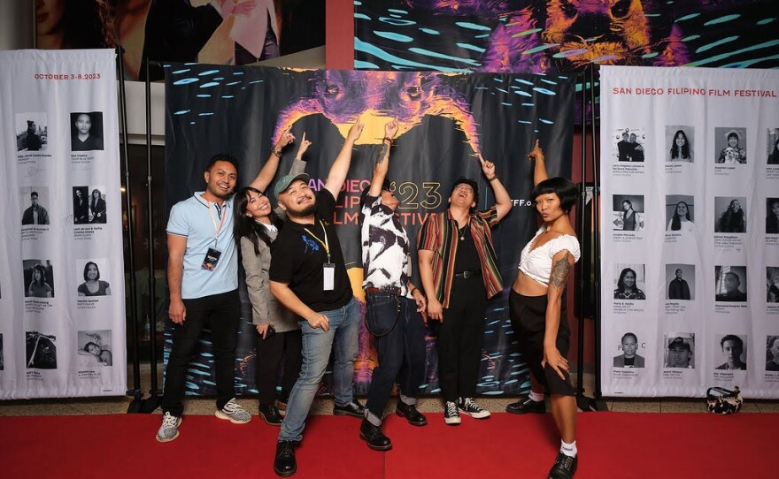 Attendees at the 2023 San Diego Filipino Film Festival point to the large banners at the AMC Plaza Bonita Theaters. Because the cinema is located in the hub of the Filipino community, the baners brought in passersby who were excited to see Filipino films on the big screen. Oct. 2023.