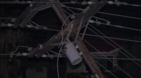 A power pole near Interstate 8 east in El Cajon that was compromised when a tractor-trailer's high-profile load snagged power lines over the freeway, Nov. 25, 2015. 