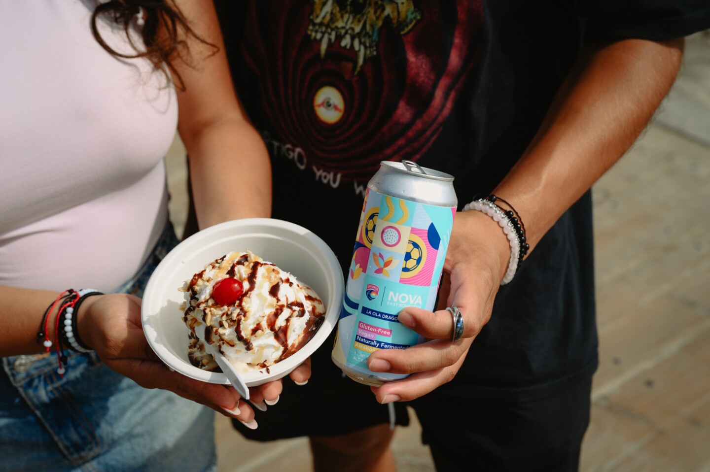 Tammy Nuñez, left, of National City and Angel de los Cobos of Nestor show off their ice cream sundae from Cow-A-Bunga Ice Cream and a can of kombucha during a date at the IB Pier in Imperial Beach, Calif. on Sept. 3, 2024.