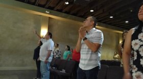 Alex Vaiz, senior pastor of Vida Church holds his hands in prayer, during a Sunday service in this undated photo. 