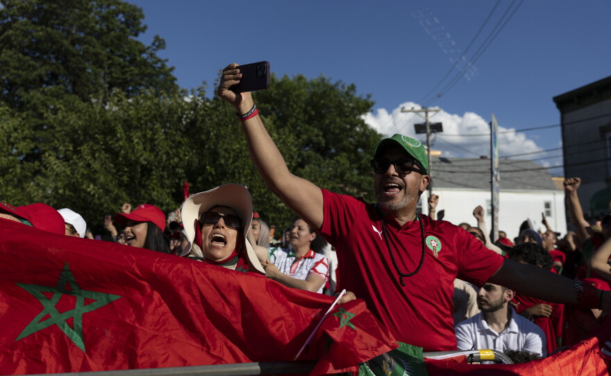Supporters of Morocco wave flags and cheer during a watch party for the FIFA World Cup match against Brazil in Paterson, N.J. on June 13.