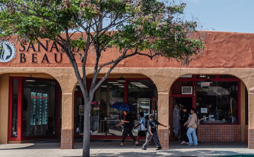 People walk passed shops on Main Street in El Cajon on June 3, 2025.