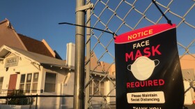 A sign reads "face mask required" in front of the McGill School of Success in the South Park neighborhood of San Diego, Calif. Oct. 13, 2021.