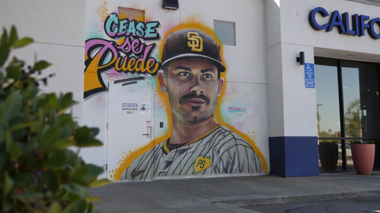 This Dylan Cease mural in Chula Vista features the Padres pitcher surrounded by bright splashes of pink, mint and yellow, inspired by the Padres' City Connect uniforms. It pays tribute to Cease's impact on the Padres since joining the clubhouse, including his no-hitter earlier in the season. (Oct. 8, 2024)